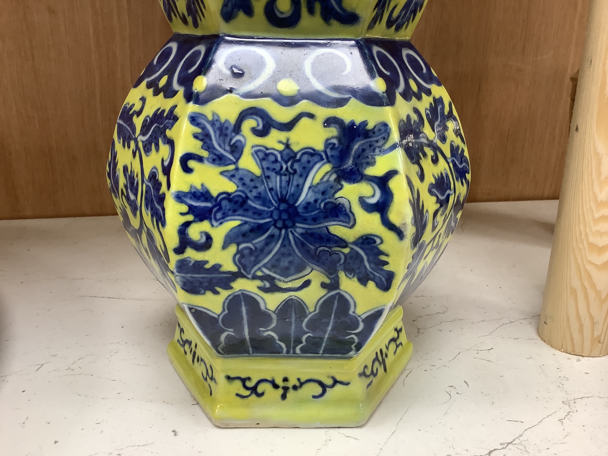 A Chinese underglaze blue yellow ground hexagonal vase, early 20th century, some restoration 35cm